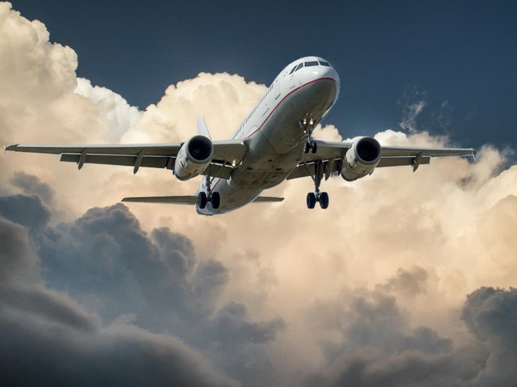 Commercial airplane flying through clouds